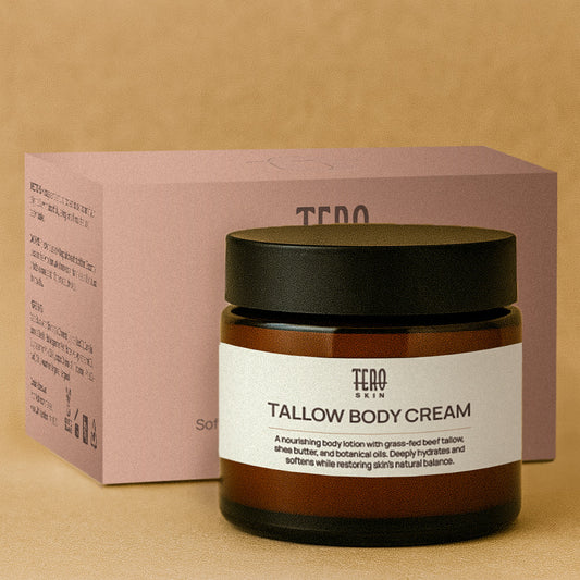 Tallow body cream jar with black lid and pink box on a beige background